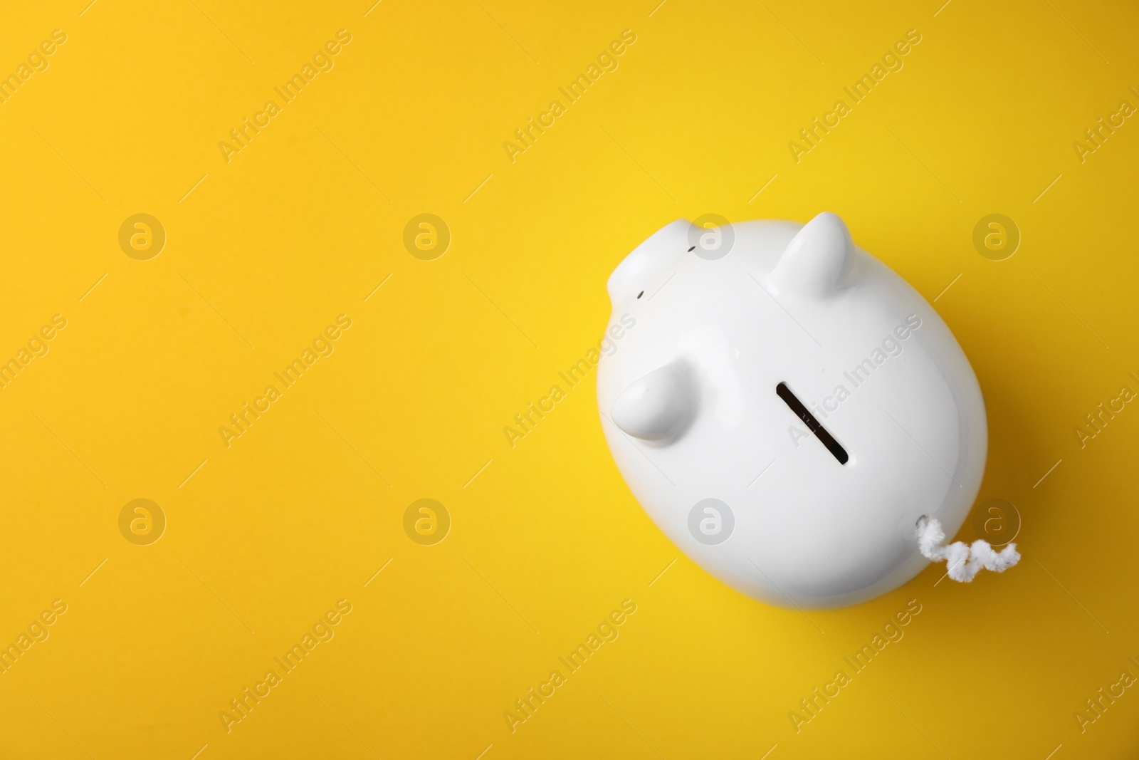 Photo of White piggy bank on color background, top view