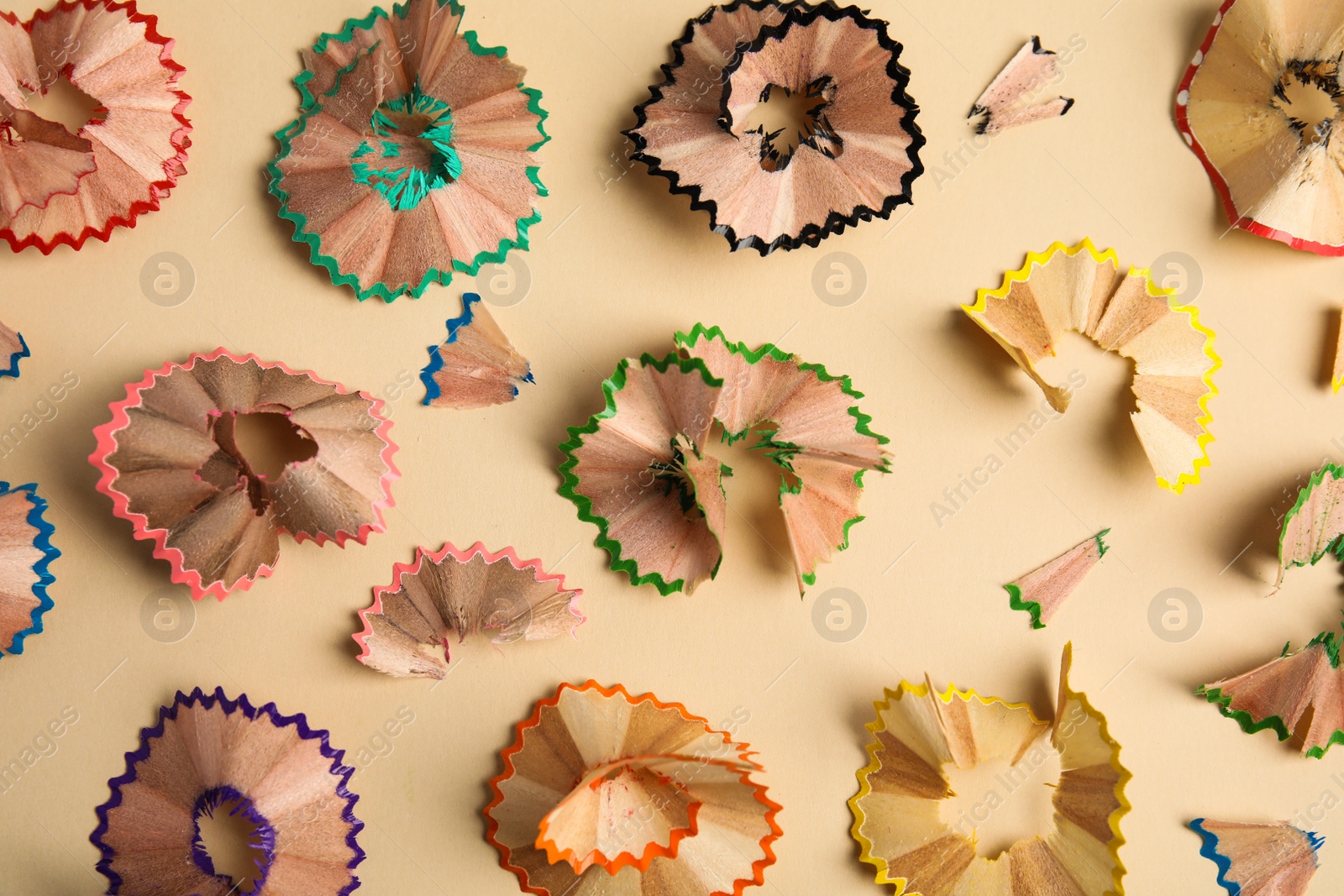 Photo of Pencil shavings on beige background, flat lay