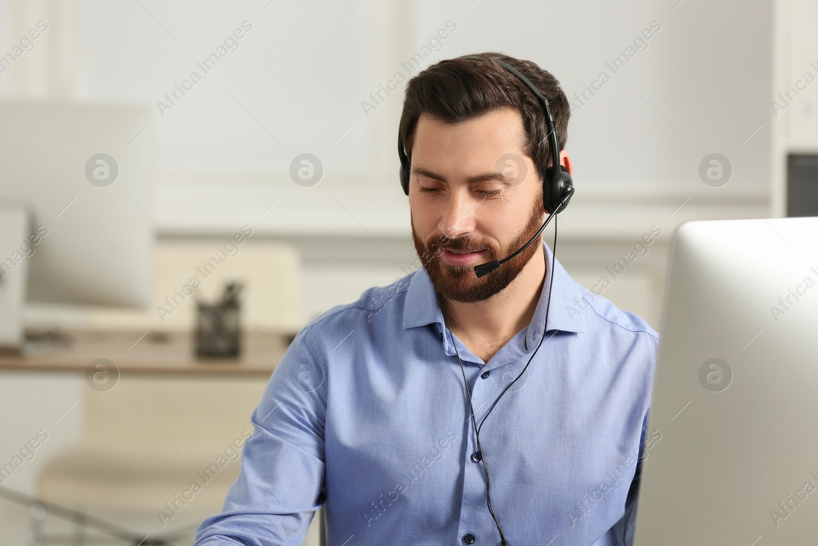 Photo of Hotline operator with headset working in office, space for text