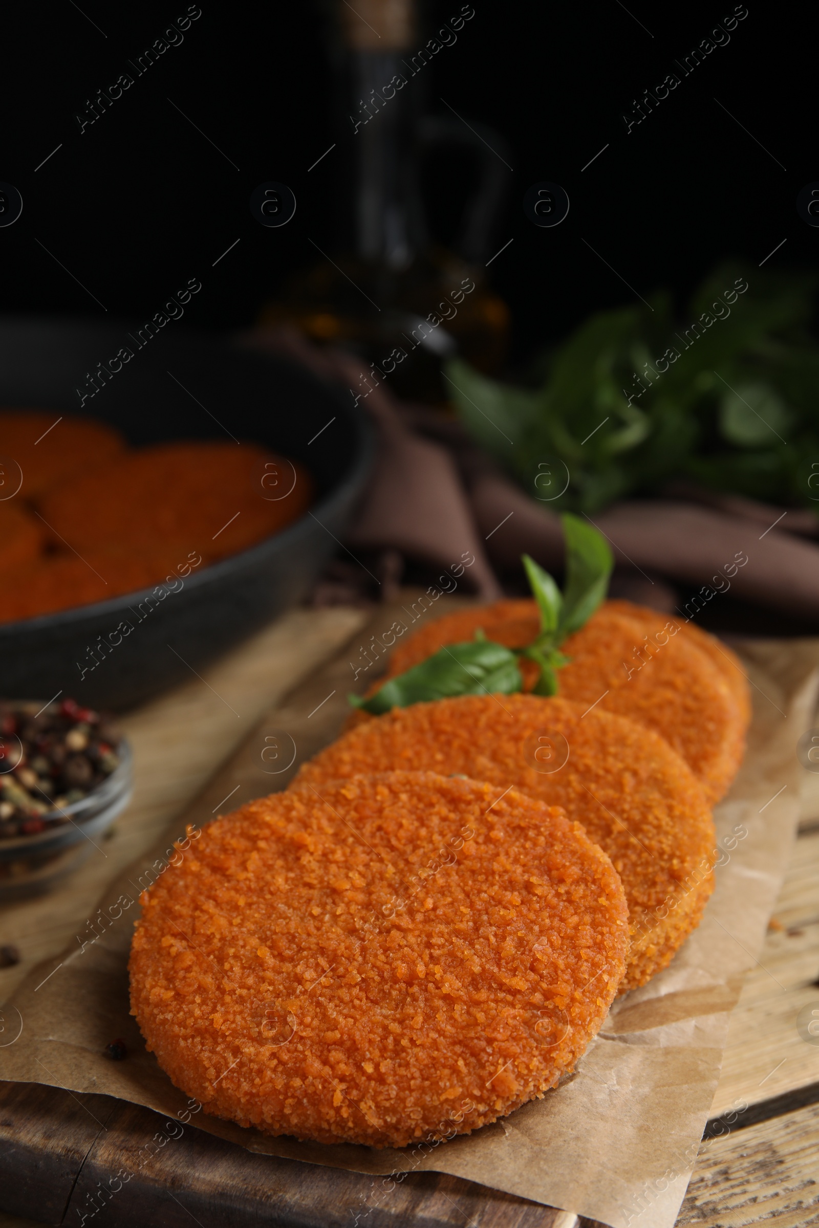 Photo of Delicious fried breaded cutlets served on wooden table, closeup