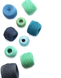 Clews of colorful knitting threads on white background, top view