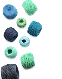 Photo of Clews of colorful knitting threads on white background, top view