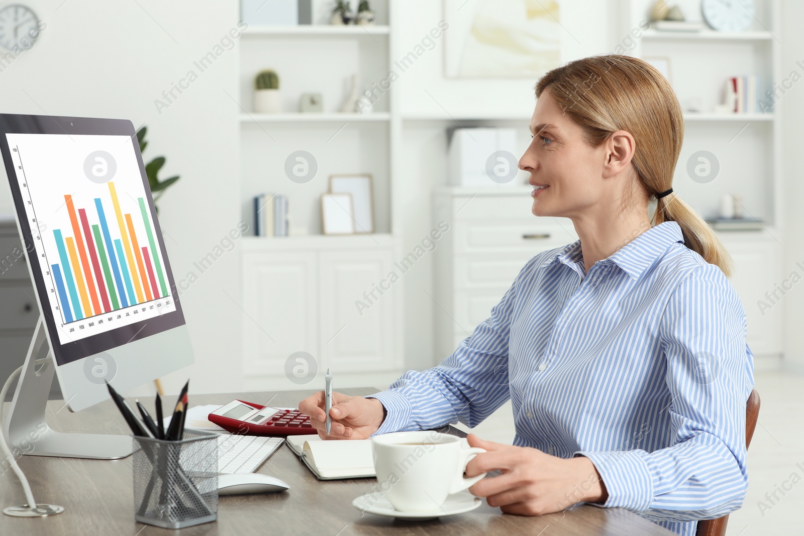 Photo of Professional accountant working at wooden desk in office