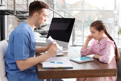 Little girl passing Rorschach test at child psychologist office