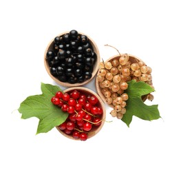 Photo of Fresh red, white and black currants with green leaves in bowls isolated on white, top view
