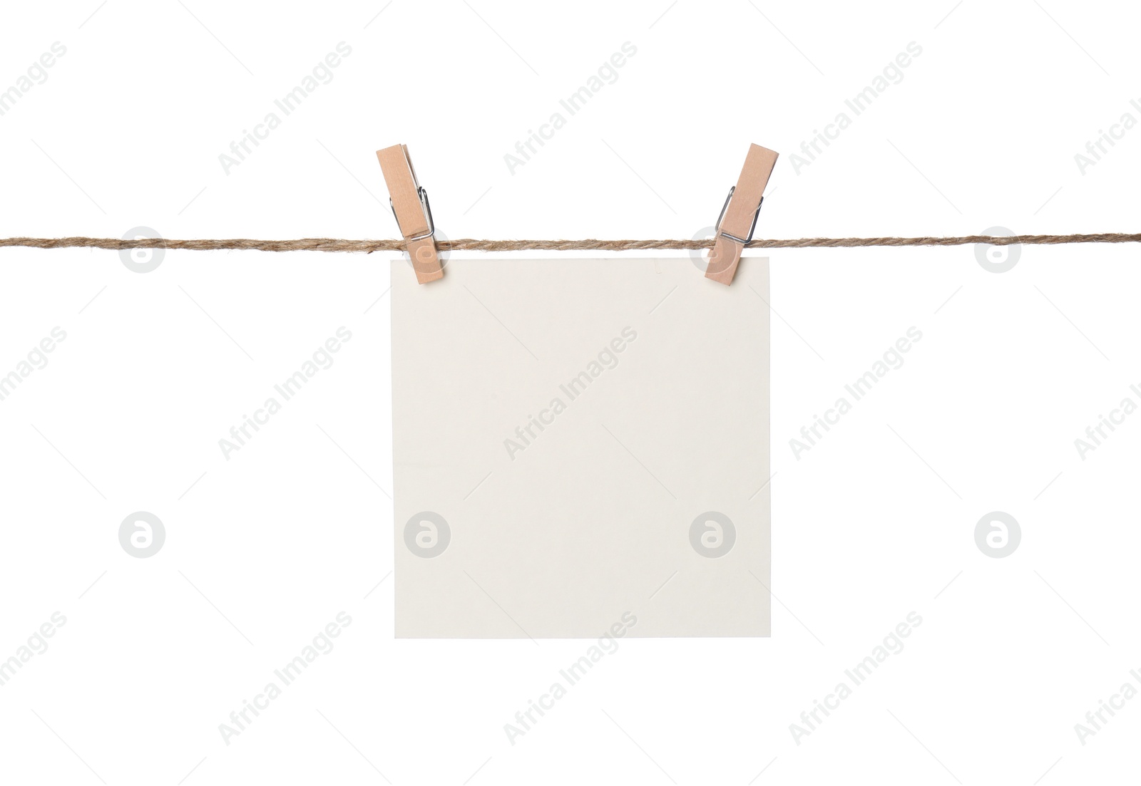 Photo of Clothespins with empty notepaper on string against white background. Space for text