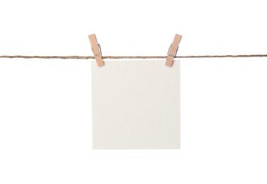 Photo of Clothespins with empty notepaper on string against white background. Space for text