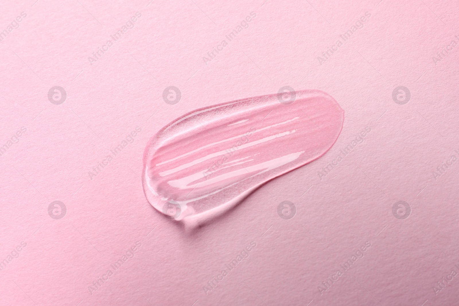 Photo of Swatch of cosmetic gel on pink background, top view