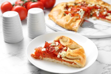 Photo of Tasty galette with tomato and cheese (Caprese galette) on white marble table, closeup