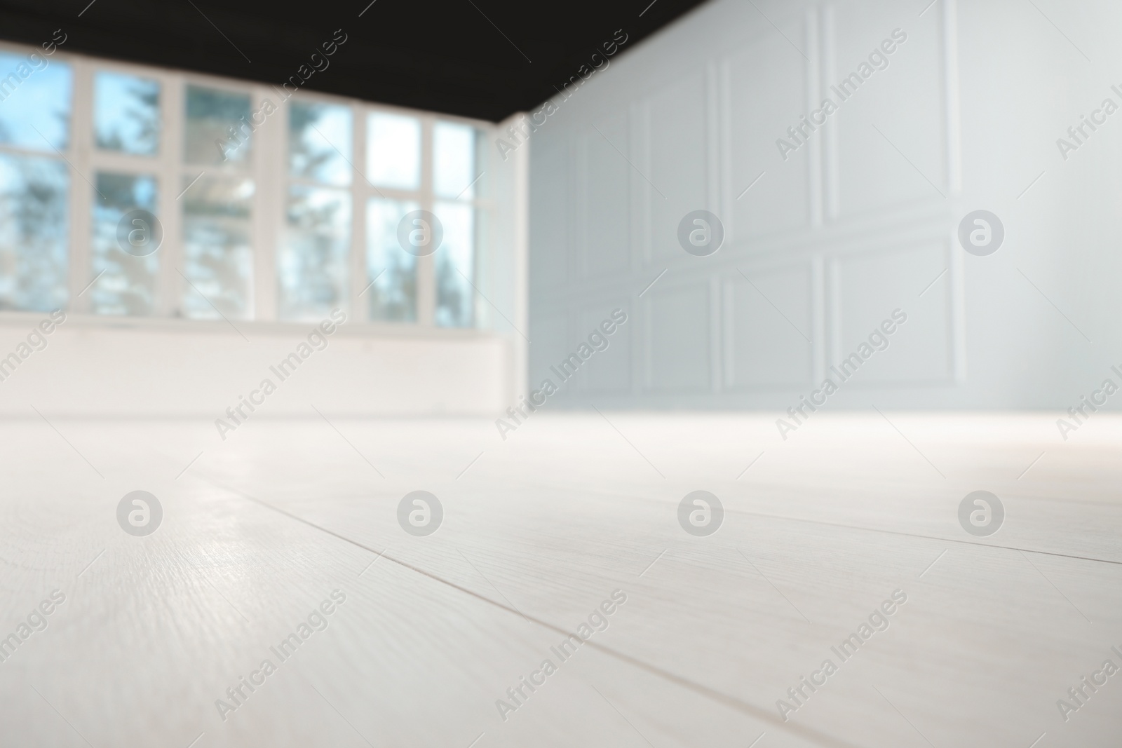 Photo of Empty room with new white laminated flooring, closeup