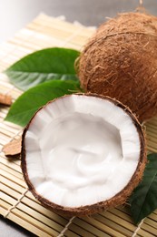 Photo of Ripe coconut with cream on bamboo mat