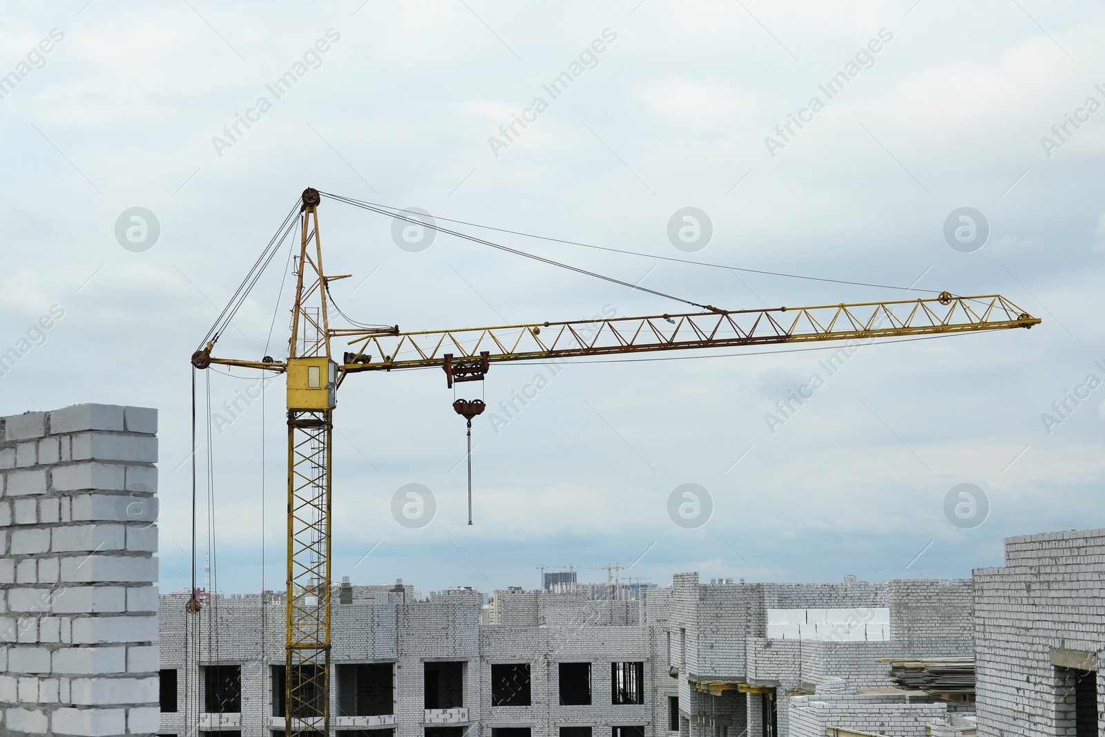 Photo of Construction site with tower crane near unfinished building