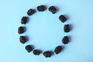 Photo of Flat lay composition with ripe blackberries on blue background. Space for text