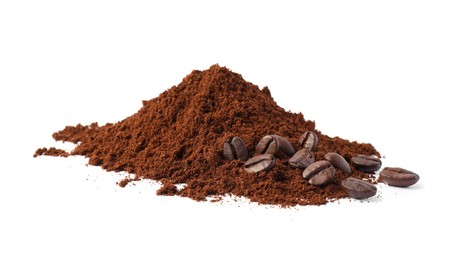 Heap of ground coffee and beans on white background