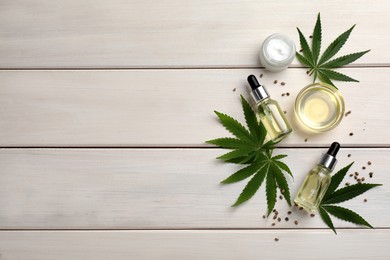 Photo of Flat lay composition with hemp leaves, CBD oil and THC tincture on white wooden table, space for text