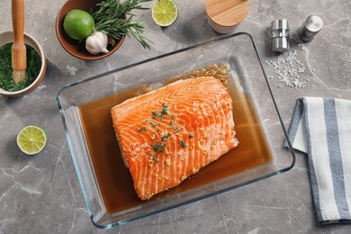 Photo of Flat lay composition with marinated salmon fillet and ingredients on table