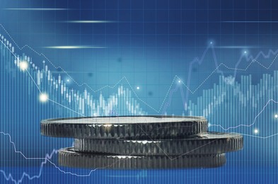 Image of Investment concept. Coins and charts on blue background