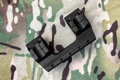 Photo of Quick disconnect sniper cantilever scope mount on fabric with camouflage pattern, top view