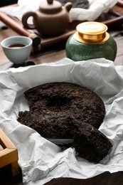 Photo of Broken disc shaped pu-erh tea on table