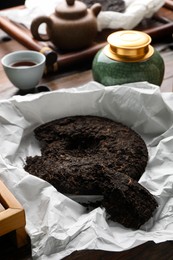 Broken disc shaped pu-erh tea on table