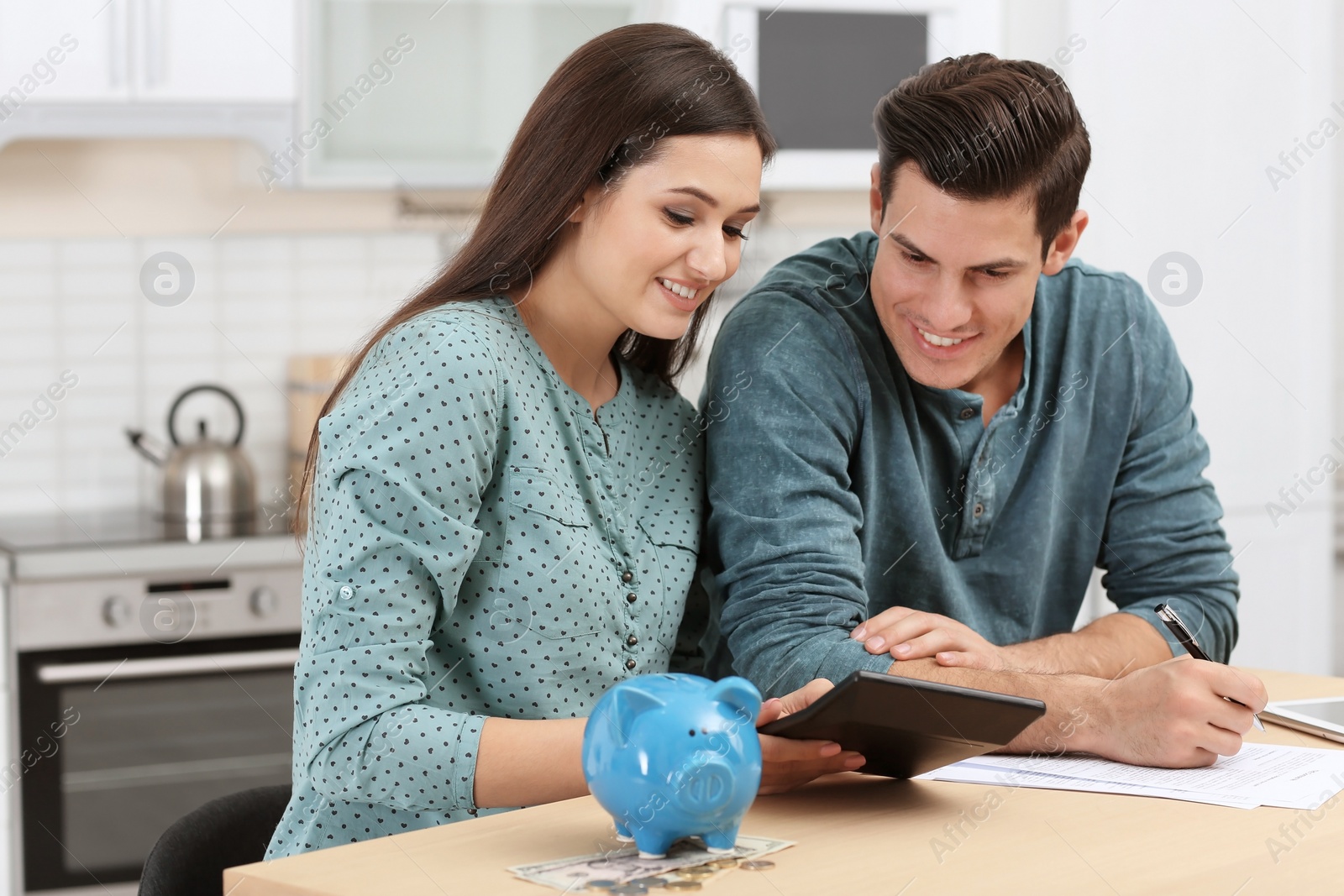 Photo of Young couple discussing pension plan at home