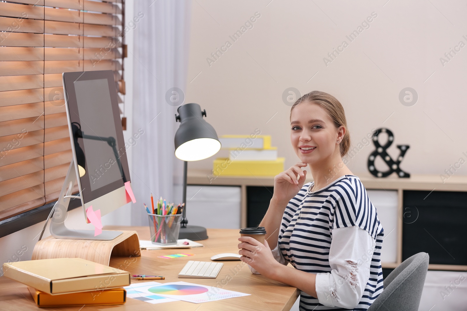 Photo of Female designer working at desk in office