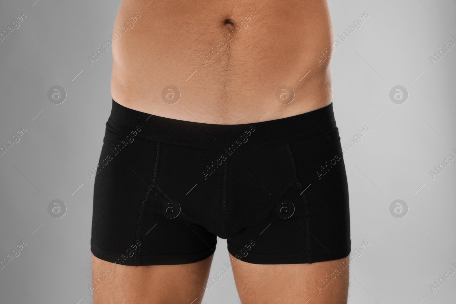 Photo of Man in black underwear on light grey background, closeup
