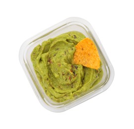 Photo of Bowl of delicious guacamole with nachos chip isolated on white, top view