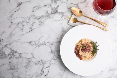 Photo of Delicious Carbonara pasta served on white marble table, flat lay. Space for text