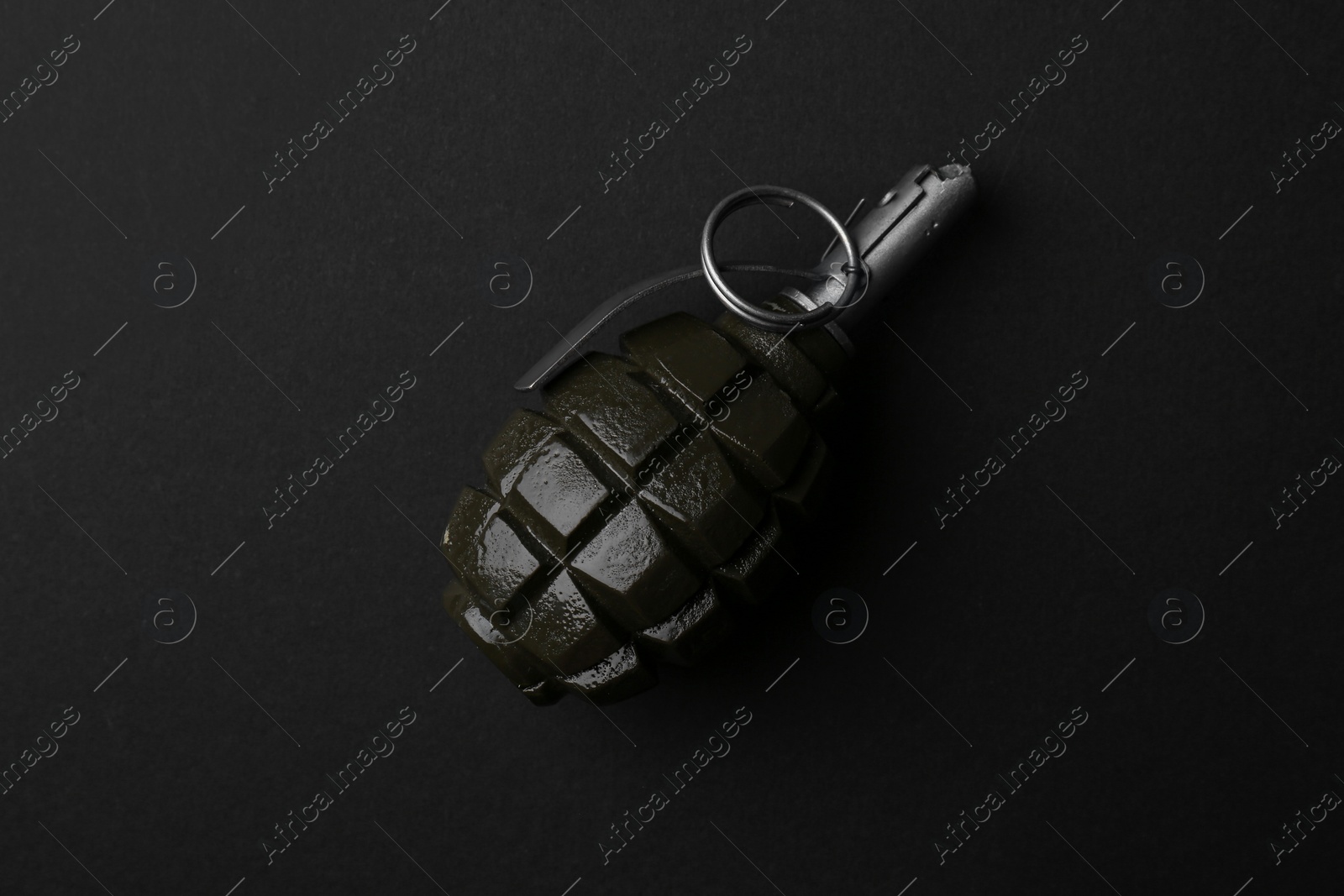 Photo of Hand grenade on black background, top view