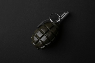 Photo of Hand grenade on black background, top view
