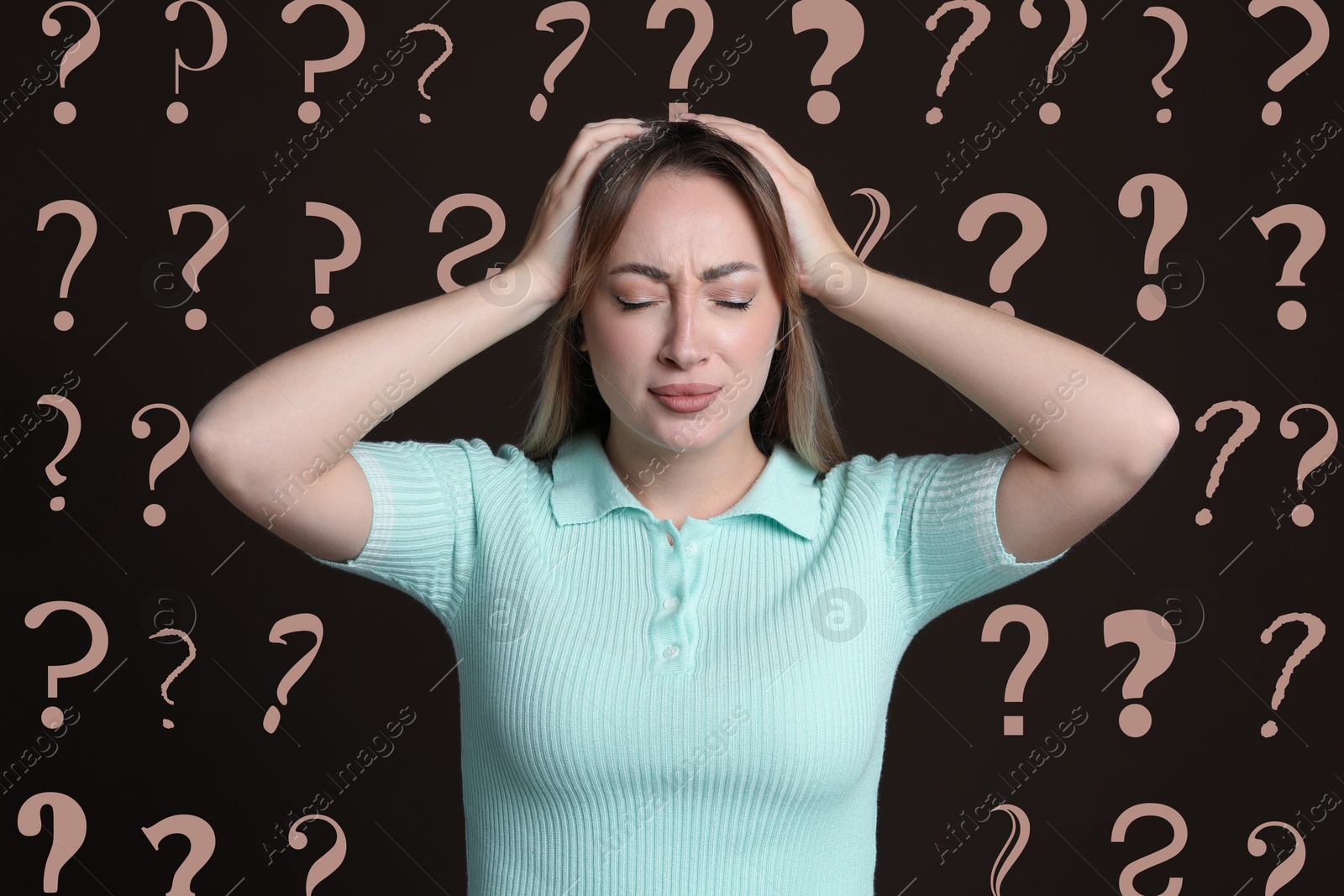 Image of Amnesia. Confused young woman and question marks on brown background