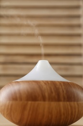 Photo of Modern aroma lamp on blurred background, closeup