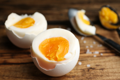 Photo of Tasty boiled chicken eggs on wooden table, closeup