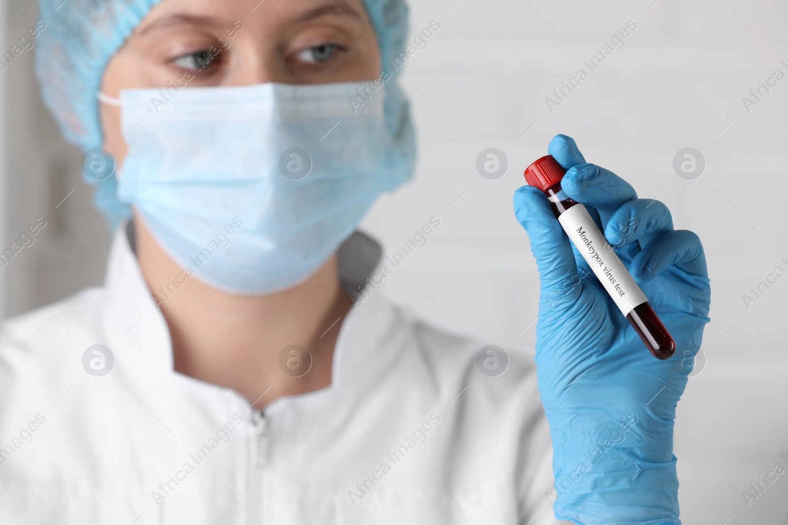 Photo of Monkeypox virus test. Laboratory worker holding sample tube with blood indoors, focus on hand