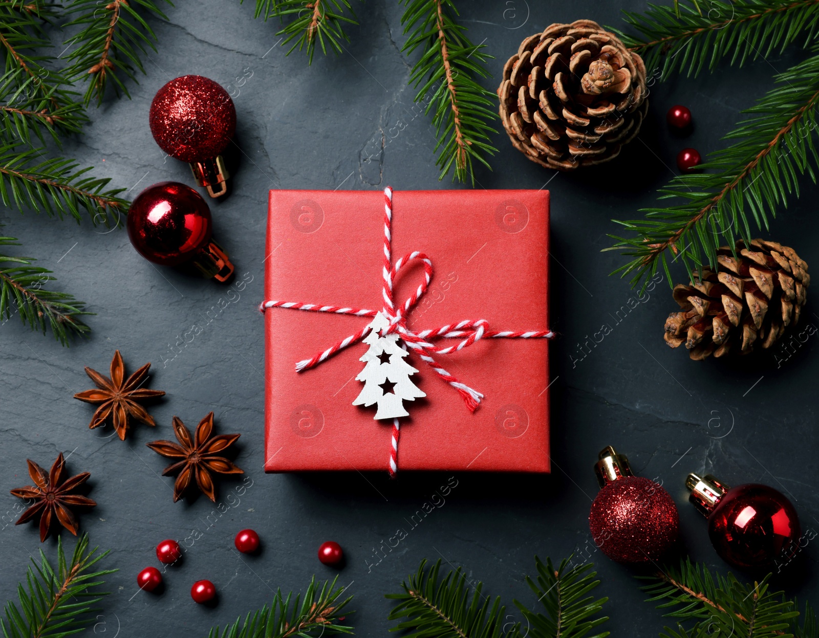 Photo of Flat lay composition with beautiful gift box and different Christmas decor on dark background