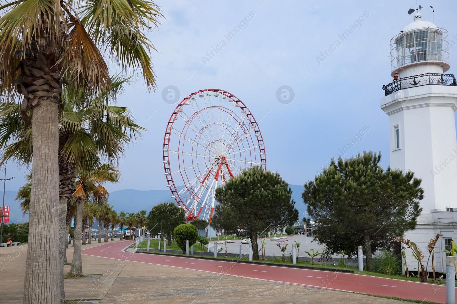 Photo of BATUMI, GEORGIA - MAY 31, 2022: Beautiful street with lighthouse and Ferris wheel