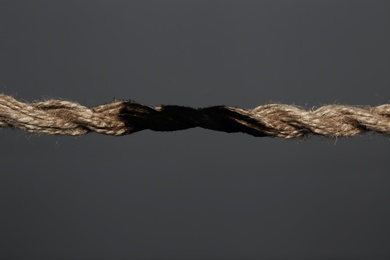 Rope burnt to breaking point on dark background