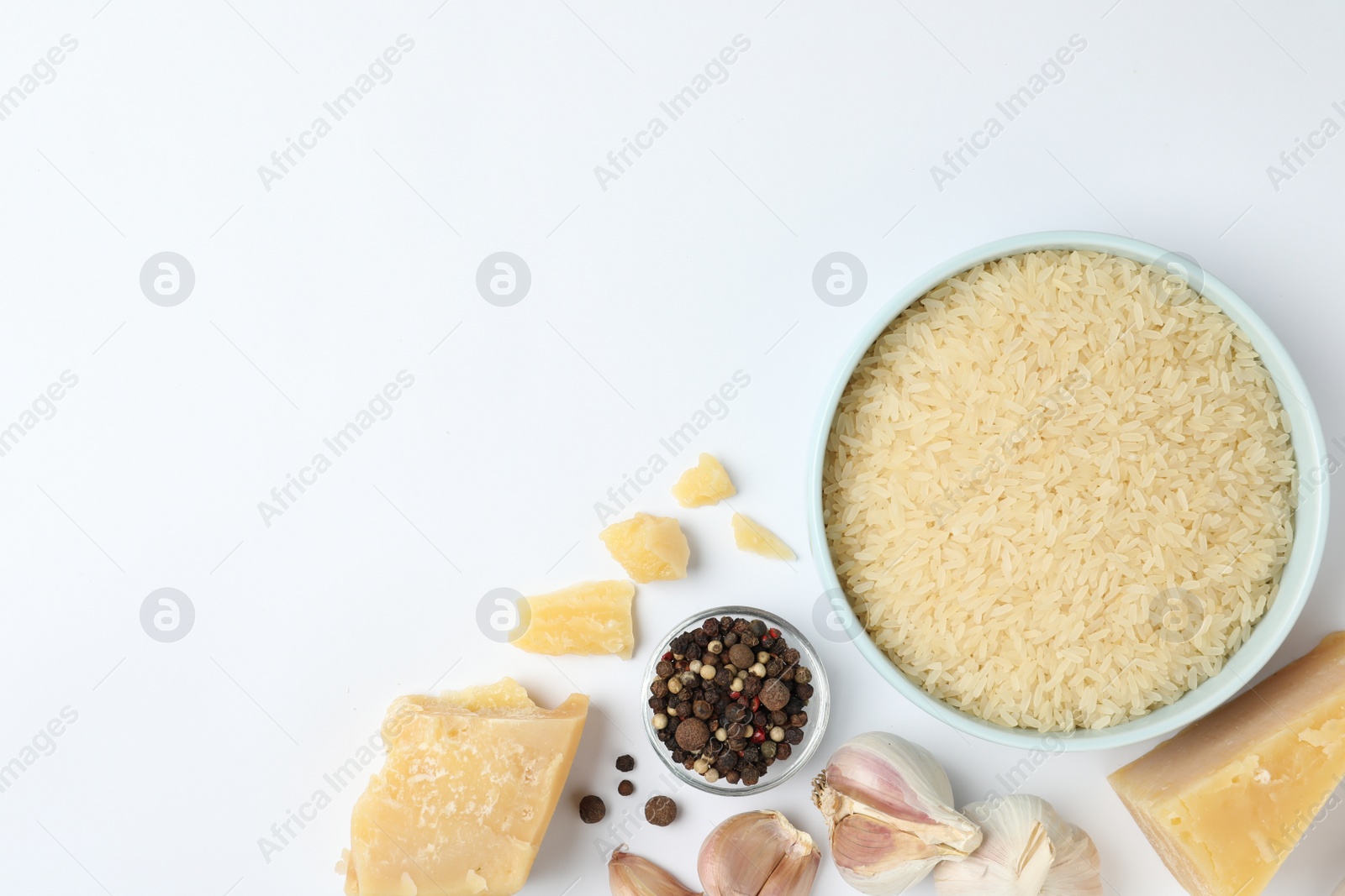 Photo of Different ingredients on white background, top view. Risotto recipe