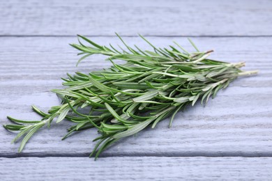 Sprigs of fresh rosemary on wooden table