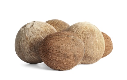 Photo of Ripe whole brown coconuts on white background