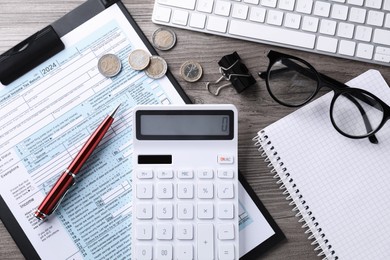 Photo of Tax accounting. Flat lay composition with calculator and document on wooden table