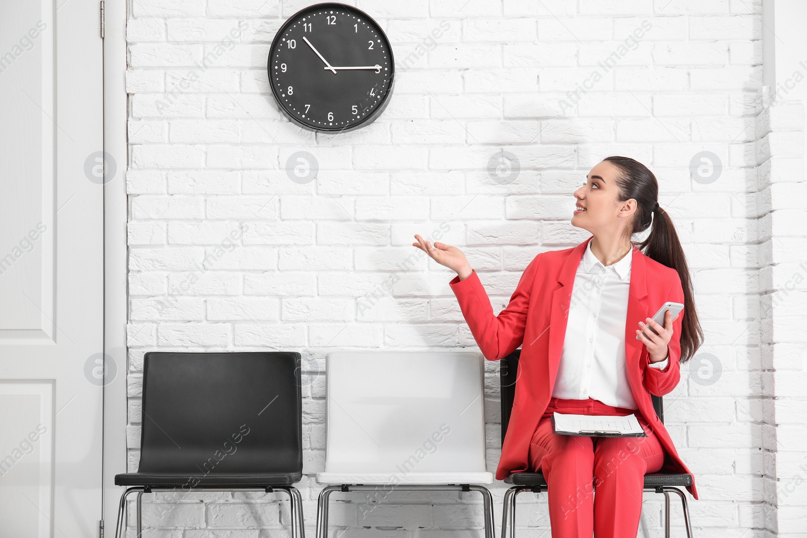 Photo of Young woman waiting for job interview, indoors