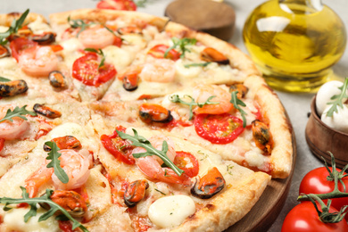 Photo of Delicious seafood pizza on table, closeup view