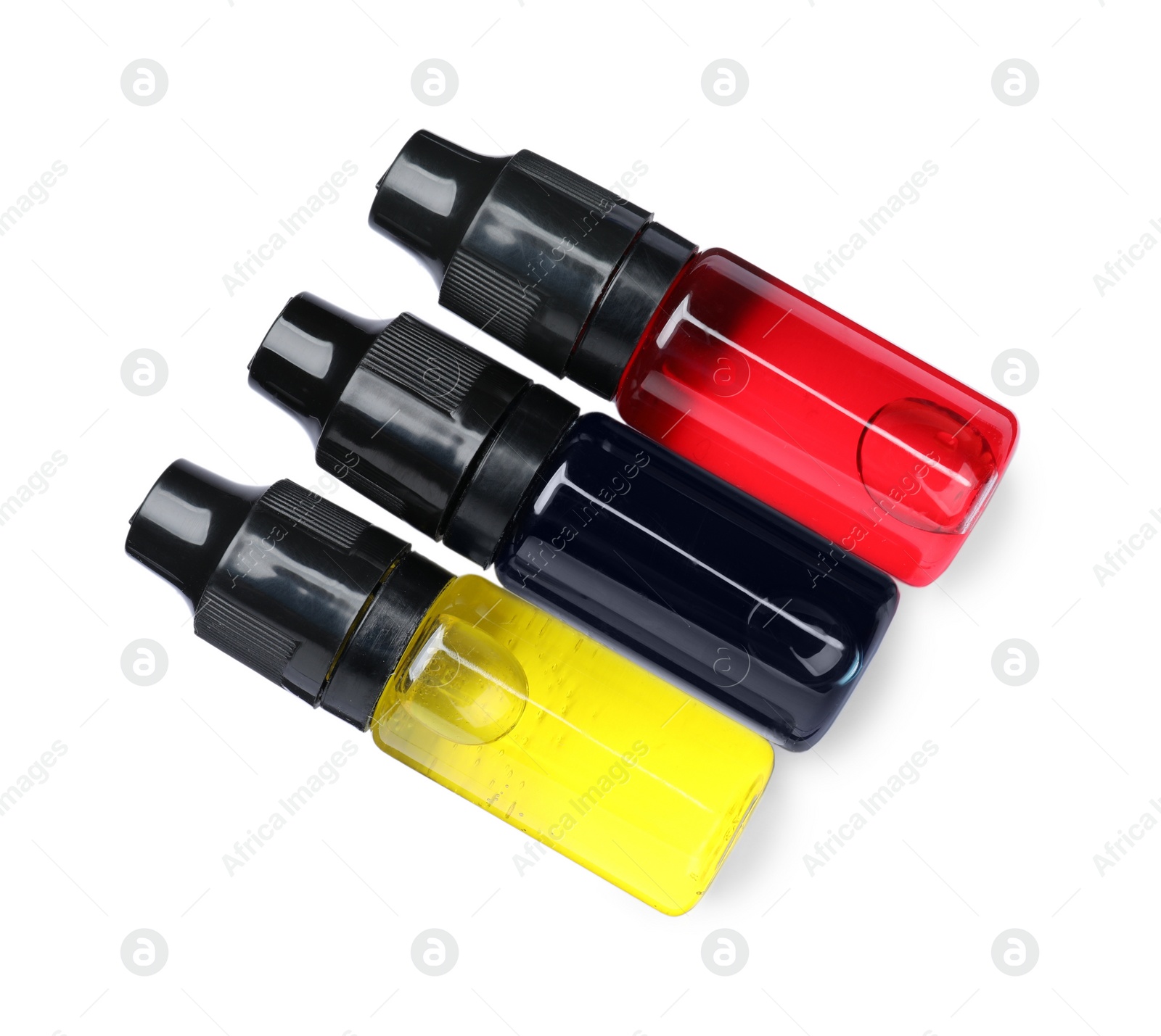 Photo of Bottles with food coloring on white background, top view