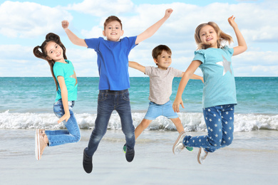 Image of Group of school children jumping on beach near sea. Summer holidays