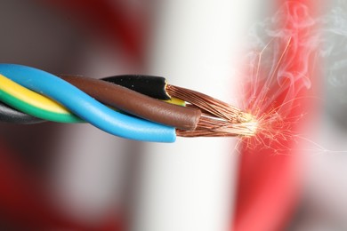 Image of Sparking wiring on blurred background, closeup view