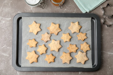 Tasty homemade Christmas cookies on baking tray, top view