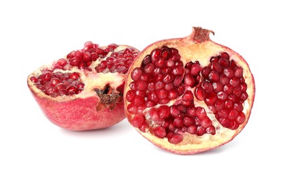 Photo of Halves of fresh pomegranate isolated on white