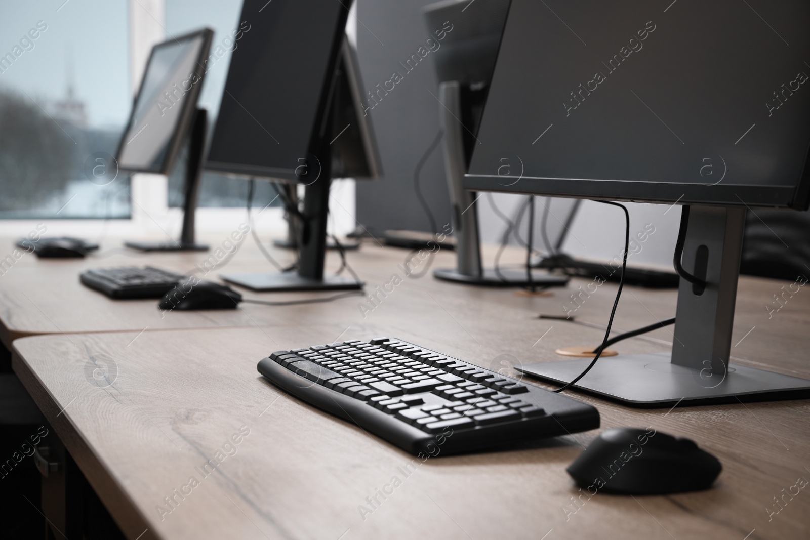 Photo of Many modern computers in open space office, closeup view